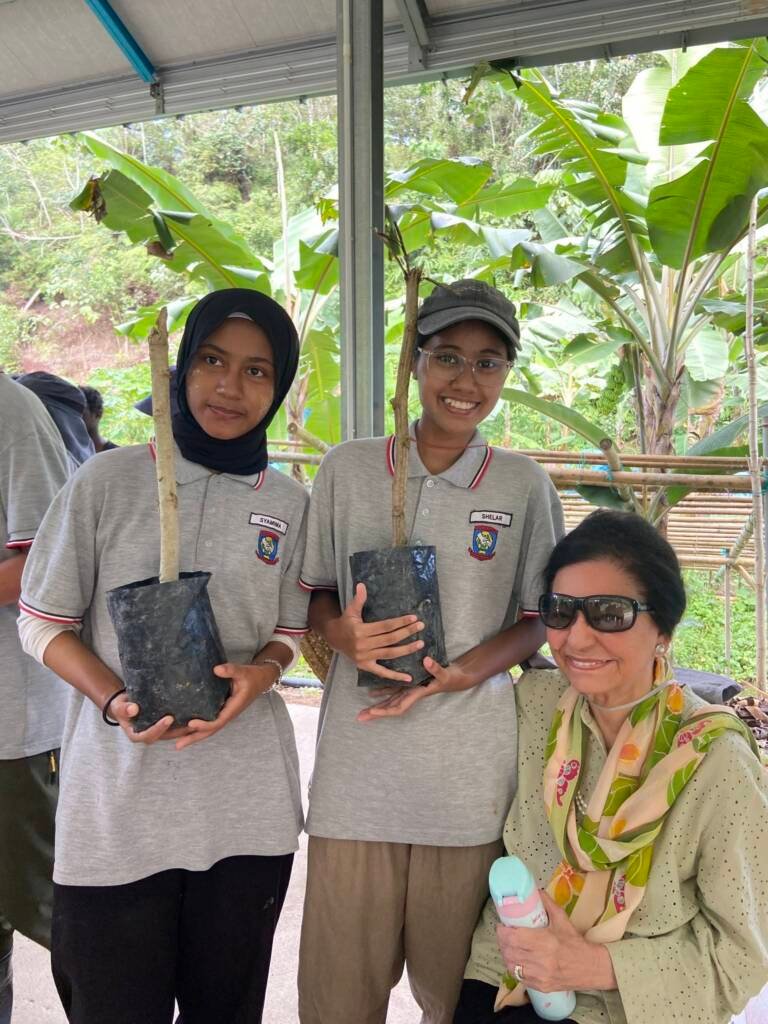 Students proudly holding their Moringa saplings