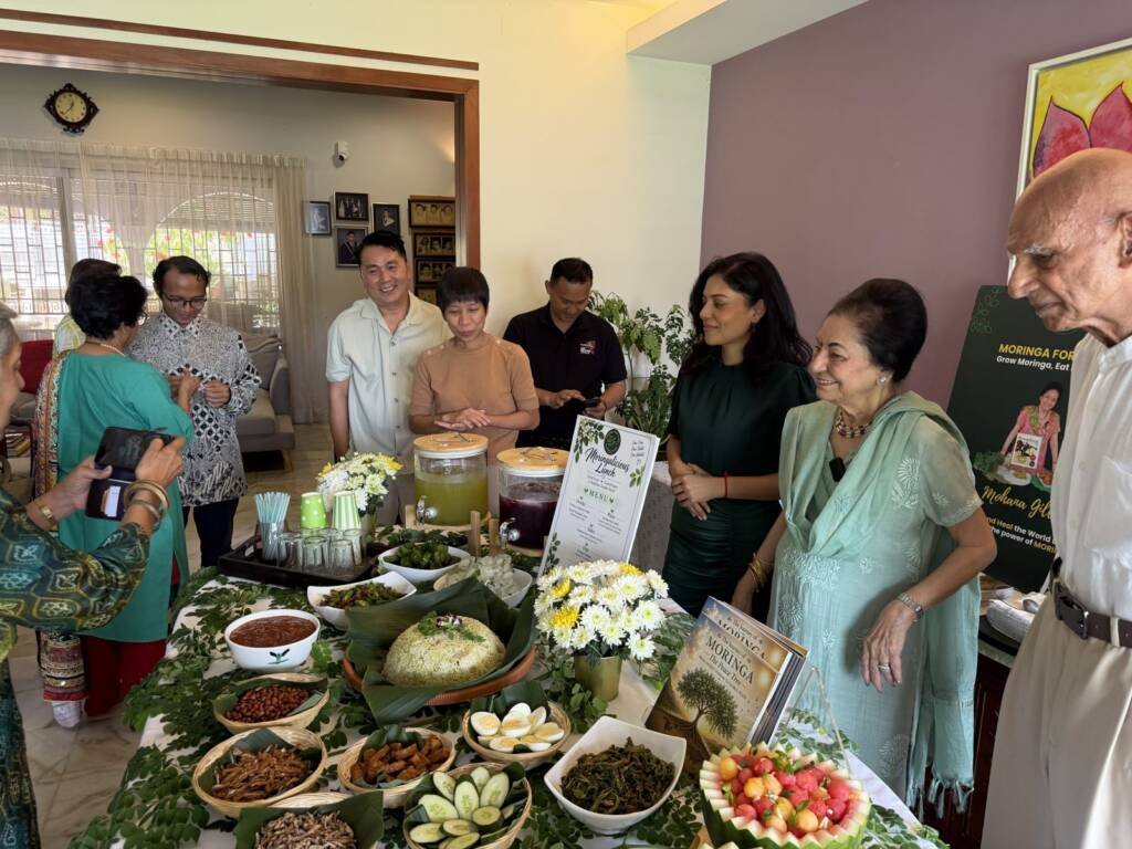 Guests gathering around the Moringalicious Lunch table